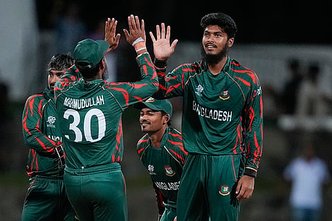 Rishad Hossain is congratulated by teammate after dismissing Travis Head